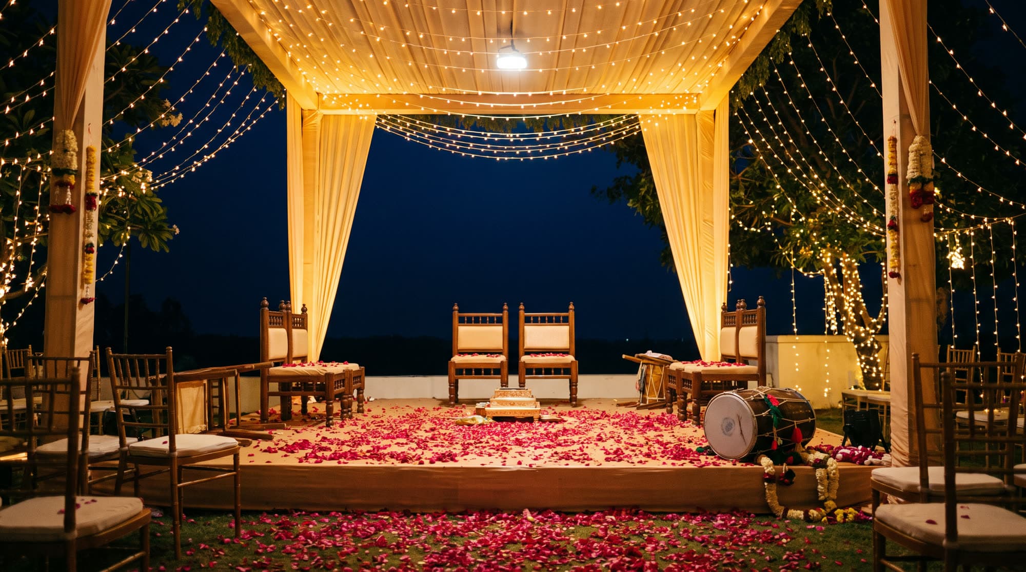 A mandap strung with fairy lights at night